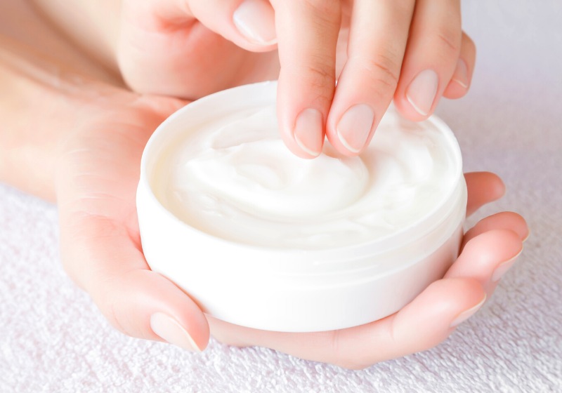 beautiful groomed woman using moisturizing cream | best way to prevent wrinkles