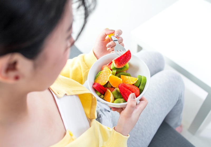 healthy looking cheerful woman eating homemade | how to prevent wrinkles in your 20s