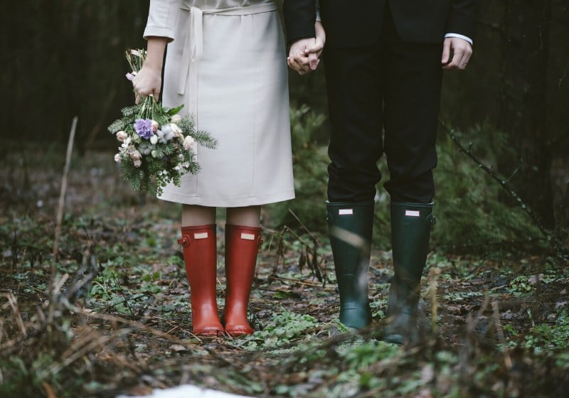 wedding couple standing forest wearing colorful | winter wear ideas for women
