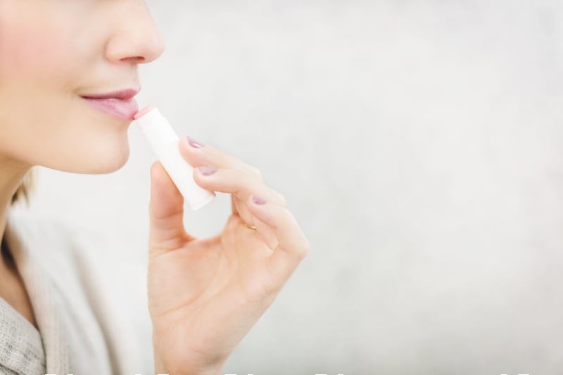 woman about to apply pink lip balm | best lip gloss brands