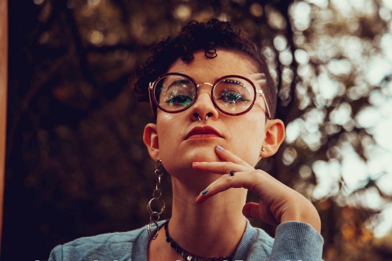woman in gray sweater wearing black framed eyeglasses | undercut fade